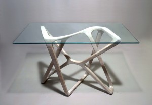 This image shows a rotationally-symmetrical wood desk base with a glass top