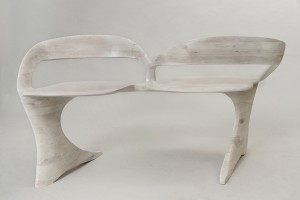 Photo of a bleached cherry loveseat sculpted by hand, seen from the front