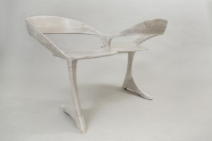 This picture shows a loveseat made of bleached cherry seen from three-quarters view