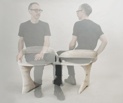 This is a photo of partially-transparent designer Aaron Scott sitting on his N2 bench